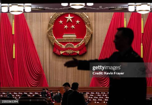 Delegates and security wait before the opening session of the National People's Congress, or NPC, at the Great Hall of the People on March 5, 2025 in...