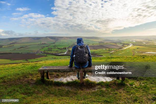 hiker sitting on bench looking at view on south downs in southeast england - landscape scenery stock pictures, royalty-free photos & images