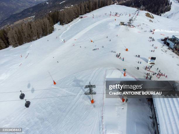 Aerial view made using a drone of an artificial snow landscape due to climate change at the La Plagne ski resort at the place called Le Fornelet...
