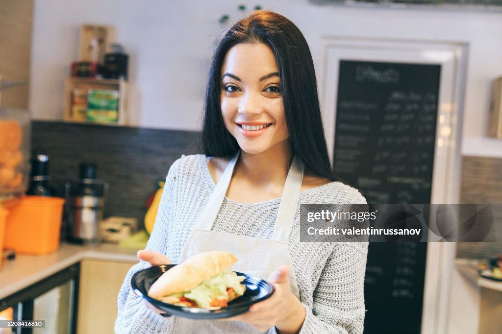Female asian worker in fast food restaurant