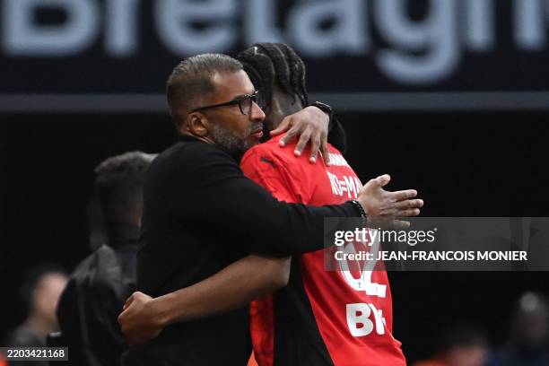 Rennes' French-Senegalese head coach Habib Beye hugs Renne's French forward Mohamed Kader Meite during the French L1 football match between Stade...