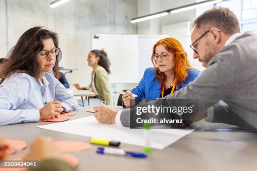 Multiracial professionals engaging in activities during seminar Multiracial professionals engaging in activities during seminar