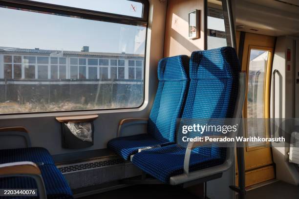 train seats bathed in natural sunlight. - fahrzeugsitz stock-fotos und bilder