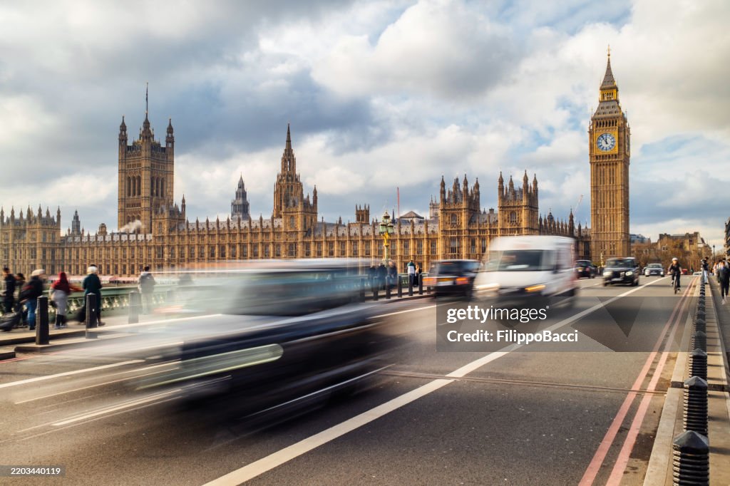 Cars driving on Westminster Bridge with Big Ben and Houses of Parliament in background