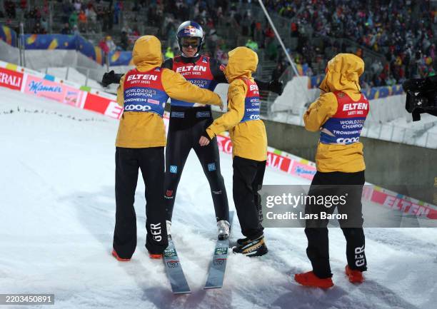 Andrea Wellinger of Team Germany embraces his teammates after the Mixed Team, Large Hill Ski Jumping of the FIS Nordic World Ski Championships...