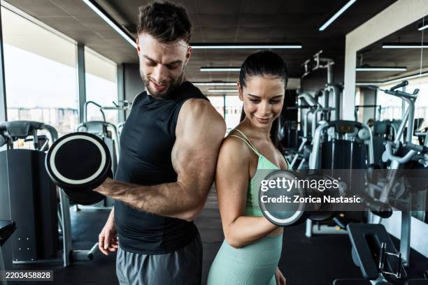 lifting dumbbells in gym - weightlifter stock pictures, royalty-free photos & images