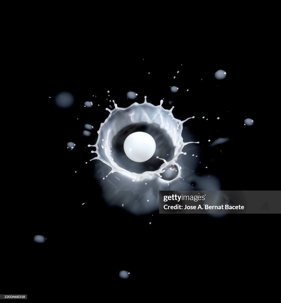 Impact and splash of milk drops falling on the floor.