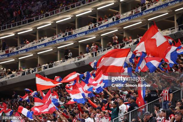 Fans of Chivas wave flags during the 11th round match between Chivas and America as part of the Torneo Clausura 2025 Liga MX at Akron Stadium on...