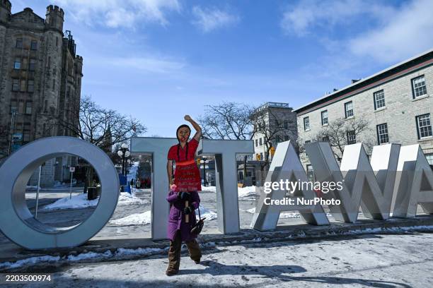 Protesters gather next to the U.S. Embassy for the 'Ottawa Ensemble pour Nos Filles' demonstration, organized by Mothers Out Front on International...