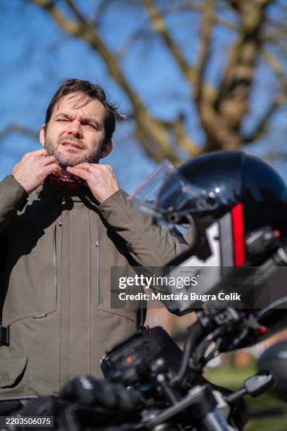 male rider young adult next to motorcycle - neck gaiter stock pictures, royalty-free photos & images