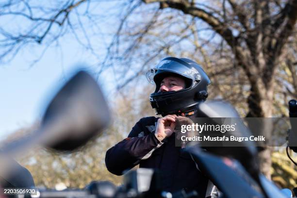 male rider getting ready to get on his motorcycle - crash helmet stock pictures, royalty-free photos & images