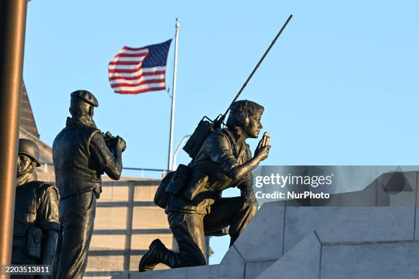 Partial view of the Reconciliation: The Peacekeeping Monument, honoring Canada's peacekeeping efforts, with the U.S. Embassy flag in the background,...