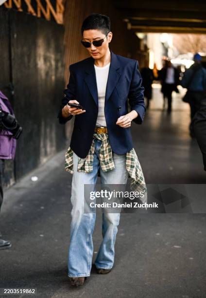 Guest is seen wearing a blue blazer, white shirt, blue jeans, plaid shirt and black sunglasses outside the Stella McCartney show during the...