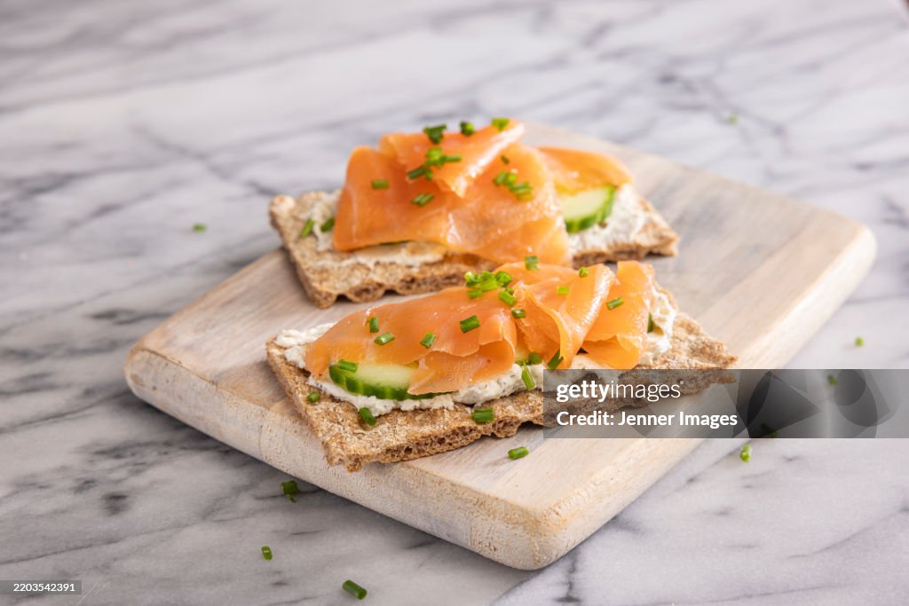 Nordic Crisp Breads with smoked salmon, cucumber and cream cheese. Topped with herbs. Trending Foods - Nordic Diet.