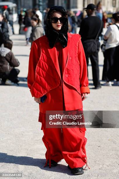 Guest wears red blazer with quilted detail, red wide leg pants, black balacla, outside Casablanca, during the Womenswear Fall/Winter 2025/2026 as...