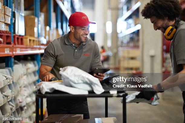 male workers enjoying while working in warehouse - warehouse worker stock pictures, royalty-free photos & images