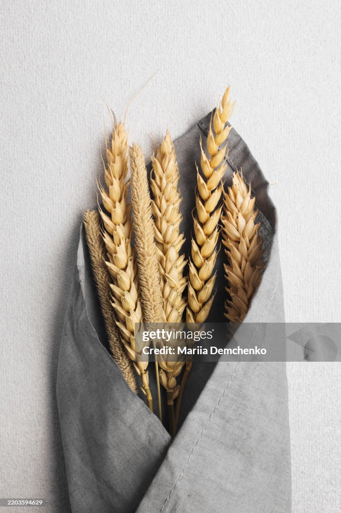 Dried wheat bouquet in gray linen fabric