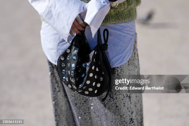 Samia Laaboudi wears a shiny black silver studded leather bag, outside Casablanca, during the Paris Fashion week Women's Fall/Winter 2025-2026 on...
