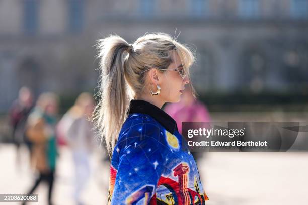 Guest wears gold earrings, silver sunglasses, navy blue quilted multicolor cropped Casablanca jacket, outside Casablanca, during the Paris Fashion...