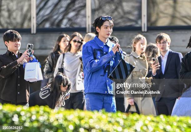 Poompat Iam-samang is seen wearing a blue Off-White shirt and pants and striped Off-White bag outside the Off-White show during the Womenswear...