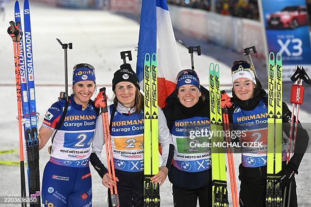Winners Team France, France's Julia Simon, France's Justine Braisaz, France's Oceane Michelon, and France's Lou Jeanmonnot-Laurent pose after the...
