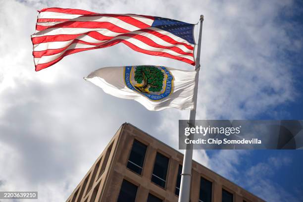 The U.S. Flag and Department of Education flags whip in the wind outside the department's headquarters on March 06, 2025 in Washington, DC. U.S....
