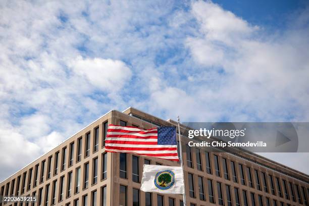 The U.S. Flag and Department of Education flags whip in the wind outside the department's headquarters on March 06, 2025 in Washington, DC. U.S....