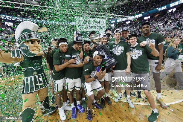 The Michigan State Spartans pose with the Big Ten Regular Season Championship Trophy after their game against the Michigan Wolverines at Breslin...