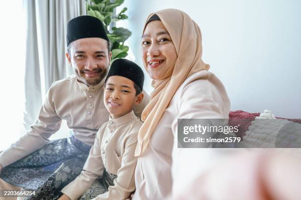 eid smiles: a family selfie at home on hari raya - malay songkok stock pictures, royalty-free photos & images