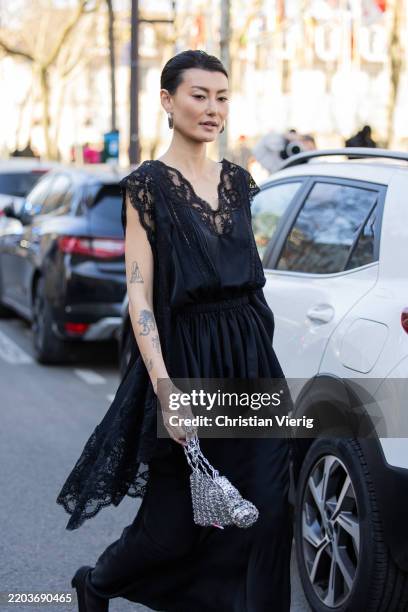 Amalie Gassmann wears black laced top, skirt, silver sequined bag outside Paco Rabanne during the Womenswear Fall/Winter 2025/2026 as part of Paris...