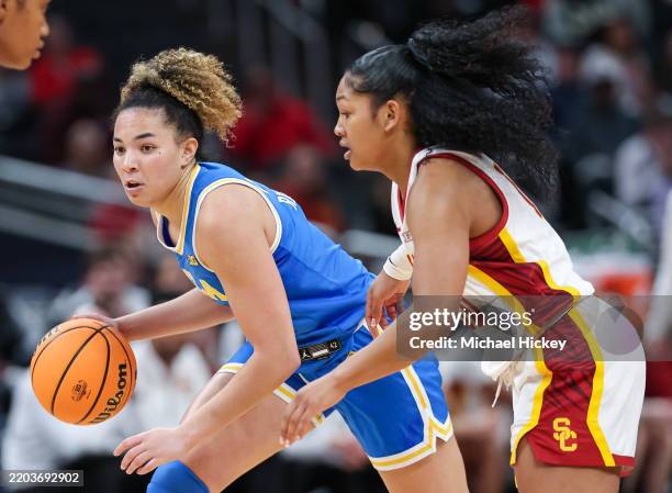 Lauren Betts of the UCLA Bruins brings the ball up court against Malia Samuels of the USC Trojans during the second half in the Big Ten Women's...