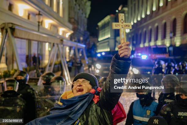 Woman delivers a speech in front of riot police during a protest on March 9, 2025 in Bucharest, Romania. Romania's electoral bureau said Sunday it...