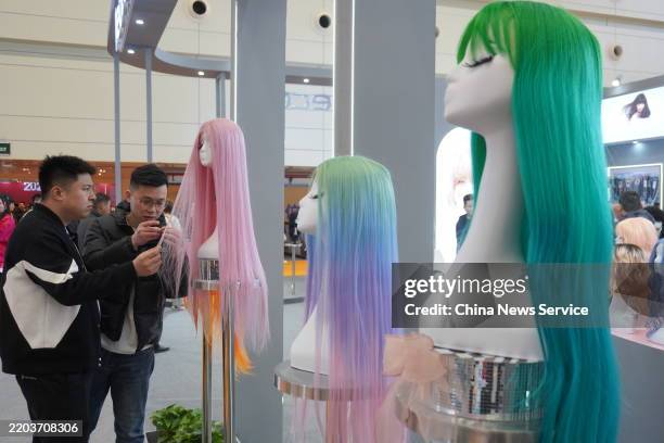 Visitors view wigs at the 2025 China Hair Products Spring Trade Fair at Zhengzhou International Convention and Exhibition Center on March 6, 2025 in...