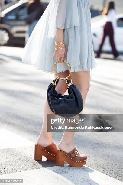 Charlotte Groeneveld wears light blue mini dress, blue Chloé bag, brown mules outside the Chloe fashion show during the Womenswear Fall/Winter...