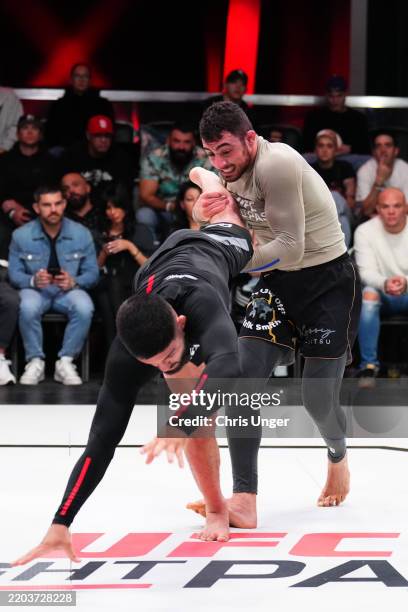 Oliver Taza grapples Renato Canuto during the UFC Fight Pass Invitational at UFC APEX on March 06, 2025 in Las Vegas, Nevada.