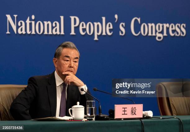 Chinese Foreign Minister Wang Yi listens to a question at a news conference on the sidelines of the Two Sessions on March 7, 2025 in Beijing, China....