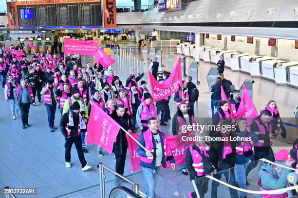 Striking airport workers gather with banners of the Komba labour union at Frankfurt Airport on March 10, 2025 in Frankfurt, Germany. Verdi, which is...