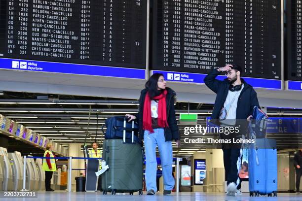 Passengers wait at Frankfurt Airport on March 10, 2025 in Frankfurt, Germany. Verdi, which is seeking wage increases from airport employers, has...