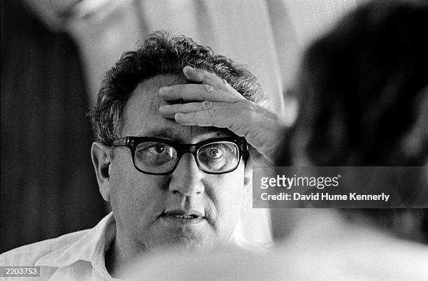 Secretary of State Henry Kissinger in the cabin of his aircraft as he flew from Alexandria, Egypt to Tel Aviv, Israel September 27, 1975 during...
