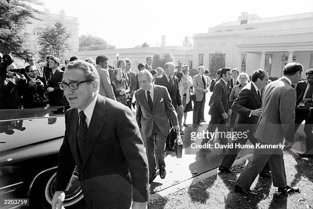 Secretary of State Henry Kissinger hurriedly leaves the White House to head back to his office at the State Department October 1973 after meeting...