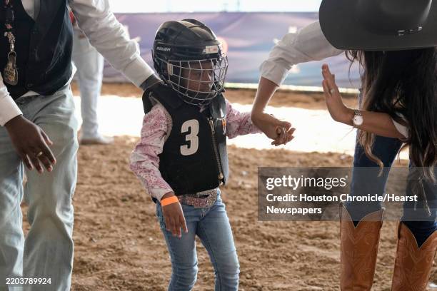 Jiana Morris is photographed after doing mutton busting at Houston ...