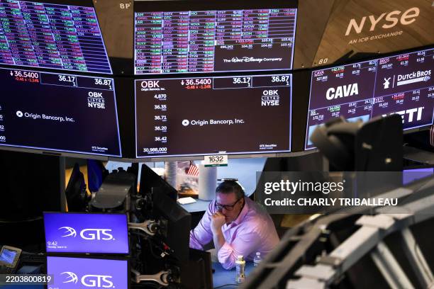 Trader works on the floor of the New York Stock Exchange at the opening bell in New York City on March 10, 2025.