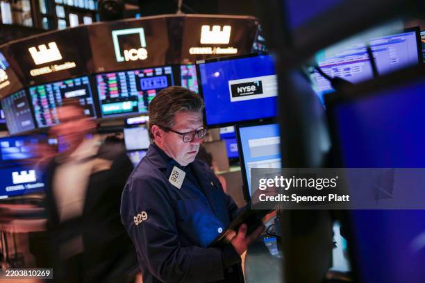 Traders work on the floor of the New York Stock Exchange on March 07, 2025 in New York City. The Dow was mixed in morning trading as confusion over...