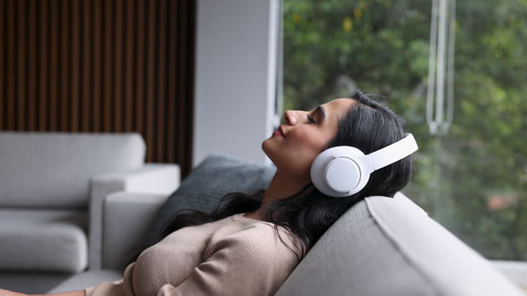 https://media.gettyimages.com/id/2203827425/video/woman-relaxing-at-home-listening-music-with-headphones.jpg?b=1&s=640x640&k=20&c=podKVVvwBqffo_af_6eDYd0BhMy3c2iZlri9efWbLos=
