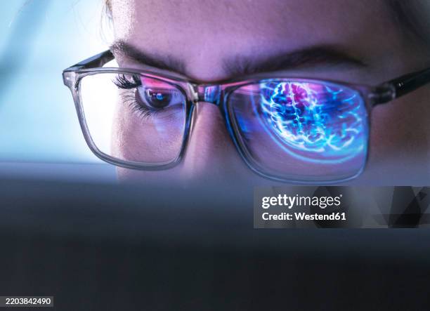 young doctor researching on patients brain mri and using computer with ai technology - neurologist stock pictures, royalty-free photos & images