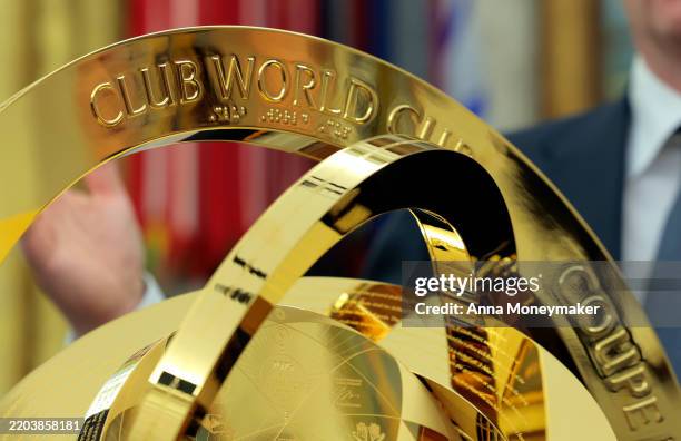 The 2025 Club World Cup trophy is unveiled during a executive order signing ceremony with U.S. President Donald Trump and President of Fédération...