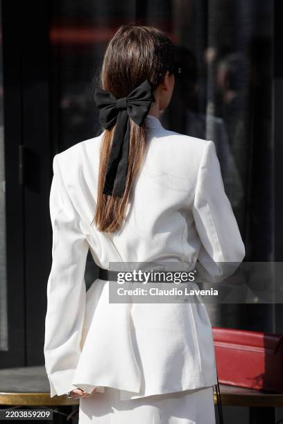Guest wears black bow hair clip detail, outside Givenchy, during the Womenswear Fall/Winter 2025/2026 as part of Paris Fashion Week on March 07, 2025...