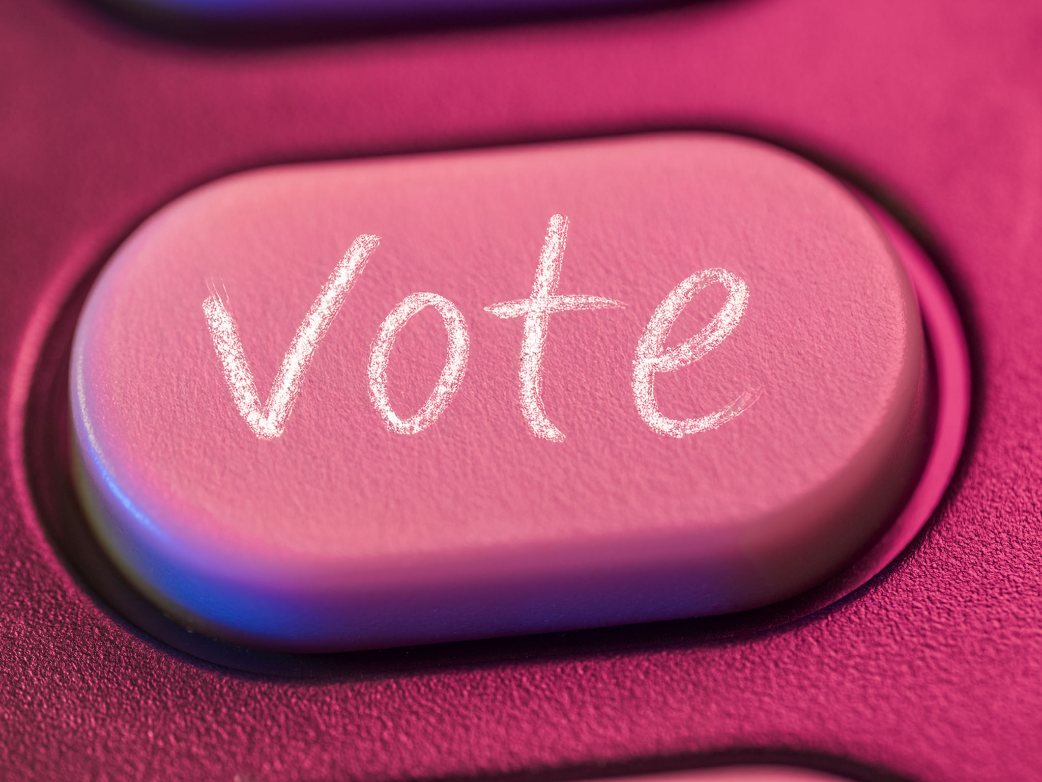 Close-up of push button with the word vote written on it in chalk Close-up of push button with the word vote written on it in chalk