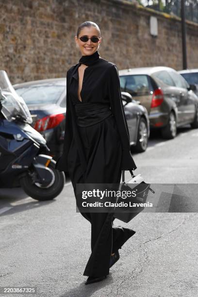 Darja Barannik wears black blouse, black trousers, black corset, black Hermes bag, outside Nina Ricci, during the Womenswear Fall/Winter 2025/2026 as...
