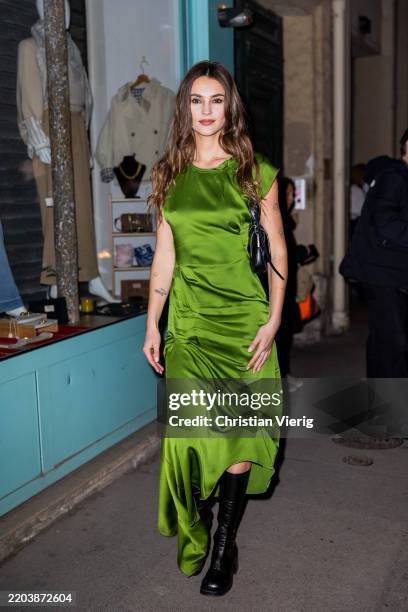 Stefanie Giesinger wears green sleeveless dress, black boots, bag outside Victoria Beckham during the Womenswear Fall/Winter 2025/2026 as part of...